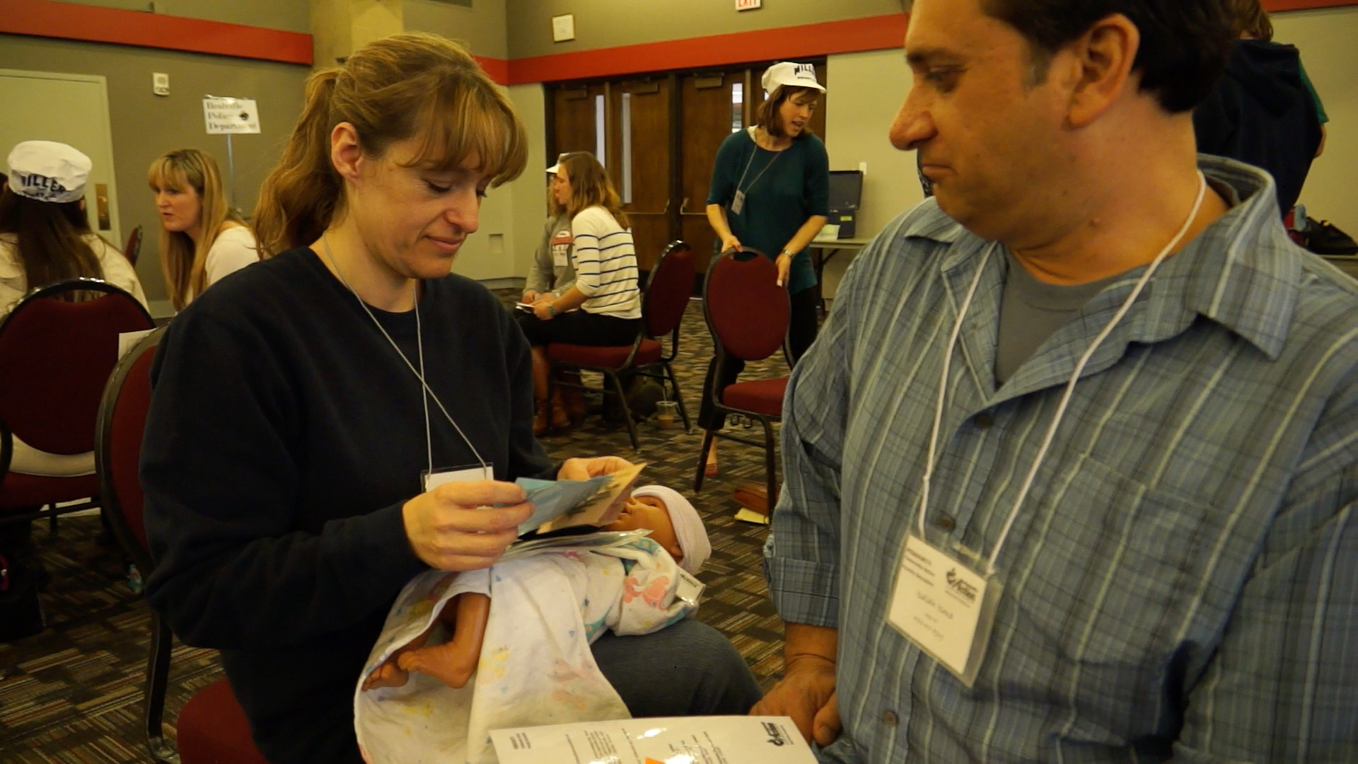 Woman and Man role play as a mother and father in a poverty simulation